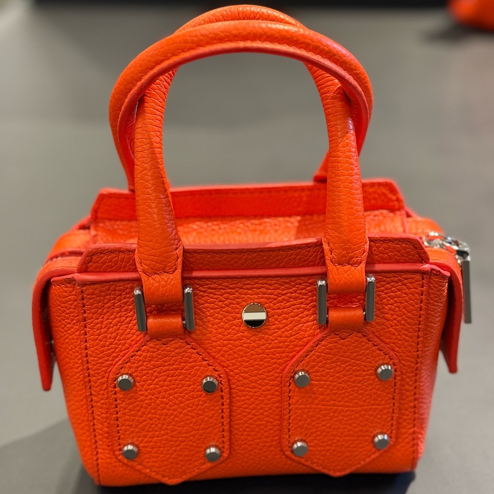 Mini size purse in color bright orange. 
From Boss
